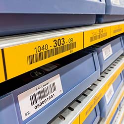 A rack in a store organized with barcode labels.