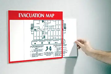 An emergency evacuation plan displayed on the wall as part of a proper OSHA safety plan.